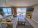 Cozy living room flowing out to balcony views, creating a harmonious blend of indoor and outdoor living spaces at 9820 Queensway Blvd. # 1603, Myrtle Beach, SC 29572
