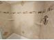 Close up of the tiled shower featuring built in shelves, niches, and decorative accents at 9820 Queensway Blvd. # 1603, Myrtle Beach, SC 29572