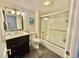 Bathroom featuring a vanity with dark cabinets, a toilet, and a tiled shower with glass doors at 9840 Queensway Blvd. # 1505, Myrtle Beach, SC 29572