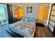 Bright bedroom featuring a colorful bedspread, lamps, and ocean view from the balcony at 9840 Queensway Blvd. # 1505, Myrtle Beach, SC 29572