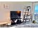 Relaxing bedroom scene featuring a decorative ladder, TV, and a view of the ocean from the balcony at 9840 Queensway Blvd. # 1505, Myrtle Beach, SC 29572