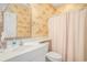 Bright bathroom featuring tropical wallpaper, modern sink, and a shower with light-colored curtain at 1000 Ray Costin Way # 107, Garden City Beach, SC 29576