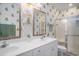 Bathroom with a double vanity, tiled walls, and a glass door shower stall at 1000 Ray Costin Way # 107, Garden City Beach, SC 29576