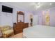 Bedroom with a dresser, TV, and doorway that leads to a bathroom and a sitting room at 1000 Ray Costin Way # 107, Garden City Beach, SC 29576