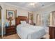 Comfortable bedroom showcasing wooden furniture, a ceiling fan, and a sunlit window with blind at 1000 Ray Costin Way # 107, Garden City Beach, SC 29576