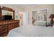 Bedroom features large wooden dresser, big mirror, closet with mirror doors and comfortable bed at 1000 Ray Costin Way # 107, Garden City Beach, SC 29576