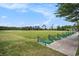 Tranquil golf course view showcasing driving range, manicured green, and picturesque scenery at 1000 Ray Costin Way # 107, Garden City Beach, SC 29576