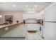 Bright kitchen featuring white cabinets, a breakfast bar, and modern appliances with tile floors at 1000 Ray Costin Way # 107, Garden City Beach, SC 29576