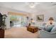 Comfortable living area featuring glass patio doors, a ceiling fan, and neutral-colored walls at 1000 Ray Costin Way # 107, Garden City Beach, SC 29576