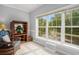 Sunroom featuring a wicker chair, wood entertainment center and view of water feature at 1000 Ray Costin Way # 107, Garden City Beach, SC 29576