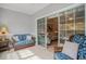 Enclosed porch with sliding doors that lead to living room with coastal themed furniture at 1000 Ray Costin Way # 107, Garden City Beach, SC 29576