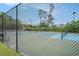 Exterior view of fenced tennis court showcasing a vibrant outdoor recreational space at 1000 Ray Costin Way # 107, Garden City Beach, SC 29576