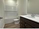 Modern bathroom with tiled shower-tub and dark wood vanity with white countertop at 1029 Jase Dr., Longs, SC 29568