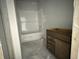 Bright bathroom features a bathtub and a new brown vanity at 1029 Jase Dr., Longs, SC 29568