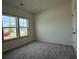 Cozy bedroom with plush carpeting and natural light from large windows at 1029 Jase Dr., Longs, SC 29568
