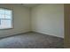 Comfortable carpeted bedroom with a bright window and neutral color scheme at 1029 Jase Dr., Longs, SC 29568