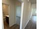Bright hallway leading to the bathroom and carpeted bedroom at 1029 Jase Dr., Longs, SC 29568