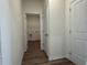 Hallway view of the laundry room with vinyl flooring at 1029 Jase Dr., Longs, SC 29568