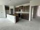 An open kitchen with unfinished cabinets and a center island awaits completion at 1029 Jase Dr., Longs, SC 29568