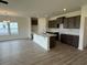 Beautiful kitchen with a large center island, stainless steel sink, and brown cabinets at 1029 Jase Dr., Longs, SC 29568