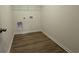 Small but practical laundry room with vinyl floor and wire shelving at 1029 Jase Dr., Longs, SC 29568