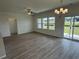 Open-concept living space with wood floors and a sliding glass door to the backyard at 1029 Jase Dr., Longs, SC 29568