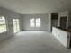 Bright living room featuring expansive windows and sliding glass doors for ample natural light, great for entertaining at 1029 Jase Dr., Longs, SC 29568