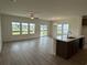 Bright, open-concept living room with wood-look floors and a modern kitchen island at 1029 Jase Dr., Longs, SC 29568