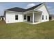 Exterior view of home featuring a covered patio and spacious grassy yard at 1033 Jase Dr., Longs, SC 29568