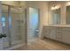 Bathroom featuring a glass enclosed shower and a vanity with double sinks and updated fixtures at 1033 Jase Dr., Longs, SC 29568