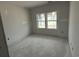An unfinished bedroom featuring dual windows, and awaiting flooring and other finishes at 1033 Jase Dr., Longs, SC 29568