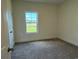 Well-lit bedroom with carpet and window offering a view of the grassy yard at 1033 Jase Dr., Longs, SC 29568