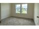 Bright bedroom with carpet and a double window offering a neighborhood view at 1033 Jase Dr., Longs, SC 29568