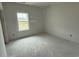 A bright bedroom features a window with views of the outdoor landscape at 1033 Jase Dr., Longs, SC 29568
