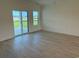 Bright bedroom with sliding glass door access to a spacious backyard and patio at 1033 Jase Dr., Longs, SC 29568