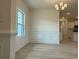 Bright dining area featuring elegant chair rail molding, modern chandelier, and wood-look floors at 1033 Jase Dr., Longs, SC 29568