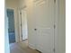 Hallway with light wood floors leading to a carpeted room through an open door at 1033 Jase Dr., Longs, SC 29568