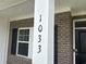 Close up of house number, 1033, on a brick home's porch column, complemented by black shutters at 1033 Jase Dr., Longs, SC 29568
