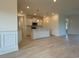 Open-concept kitchen with white cabinets, a center island, stainless steel appliances and modern recessed lighting at 1033 Jase Dr., Longs, SC 29568