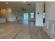 Spacious, light-filled living area with wood-look flooring and sliding glass doors to the backyard at 1033 Jase Dr., Longs, SC 29568