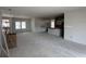 Unfinished open living space with large windows and partially installed kitchen cabinets ready to be customized at 1033 Jase Dr., Longs, SC 29568