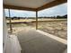 View from the covered patio, showcasing the spacious backyard and neighborhood homes at 1033 Jase Dr., Longs, SC 29568