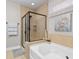 Relaxing bathroom featuring a soaking tub, tiled walk-in shower, and neutral decor at 1035 Brentford Pl., Myrtle Beach, SC 29579