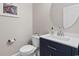 Stylish powder room features modern fixtures, white countertops and sink, and navy blue cabinet at 1035 Brentford Pl., Myrtle Beach, SC 29579