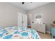 Bright bedroom with colorful seashell-themed bedding, neutral walls, and carpeted floor at 1035 Brentford Pl., Myrtle Beach, SC 29579