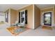 Charming front porch with seating area and a colorful rug creates a welcoming entrance at 1035 Brentford Pl., Myrtle Beach, SC 29579