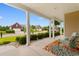 Inviting front porch with colorful rug and chairs, offering a cozy outdoor living space with views of the neighborhood at 1035 Brentford Pl., Myrtle Beach, SC 29579