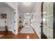 Bright hallway with hardwood floors, wainscoting, and decorative rugs leading to a welcoming living space at 1035 Brentford Pl., Myrtle Beach, SC 29579