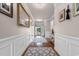 Inviting hallway with hardwood floors and elegant wall decor, leading to the home's entrance at 1035 Brentford Pl., Myrtle Beach, SC 29579