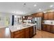Spacious kitchen with a large island featuring granite countertops, stainless steel appliances, and ample cabinet space at 1035 Brentford Pl., Myrtle Beach, SC 29579